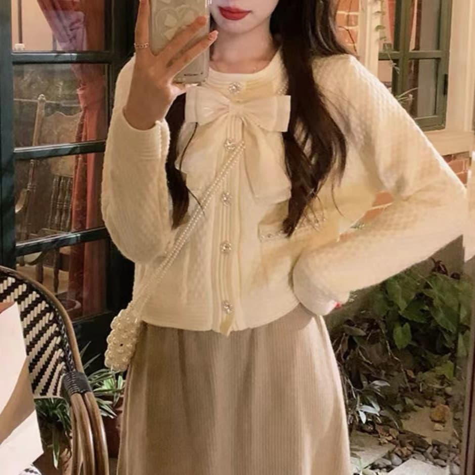 フレンチガーリー パール調ボタン付き大きめリボンニットカーディガン